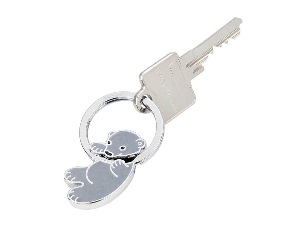 TROIKA KOALA BABY keyring featuring an adorable grey koala with a tactile fur-effect surface and shiny chrome-plated finish. A cute gift for animal lovers.