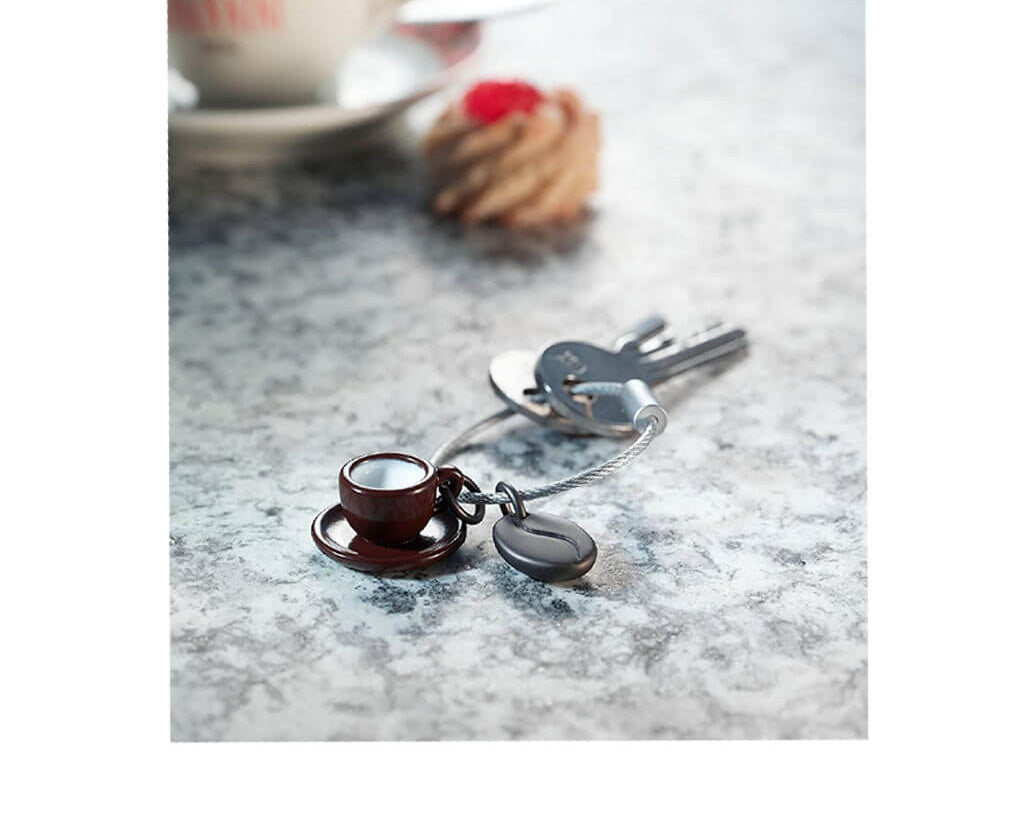 Troika keychain "Coffee 2 GO" on table with coffee mug