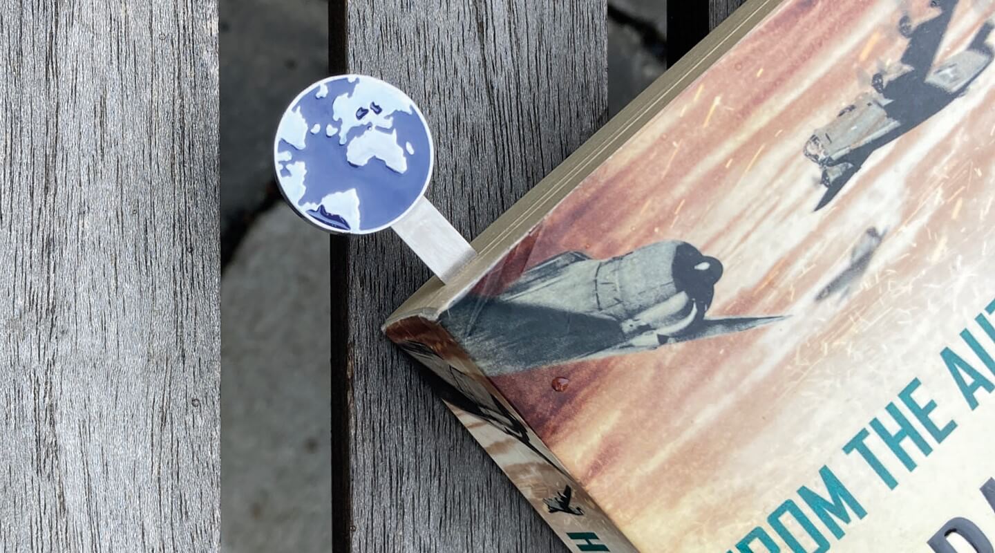 Bookmark with motif globe in a book