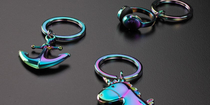 3 design keychains on table