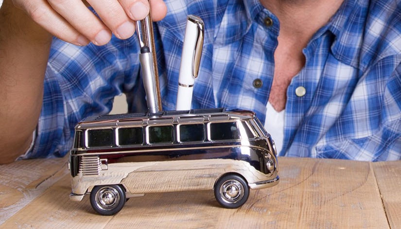 man with Volkswagen model as a desk accessory