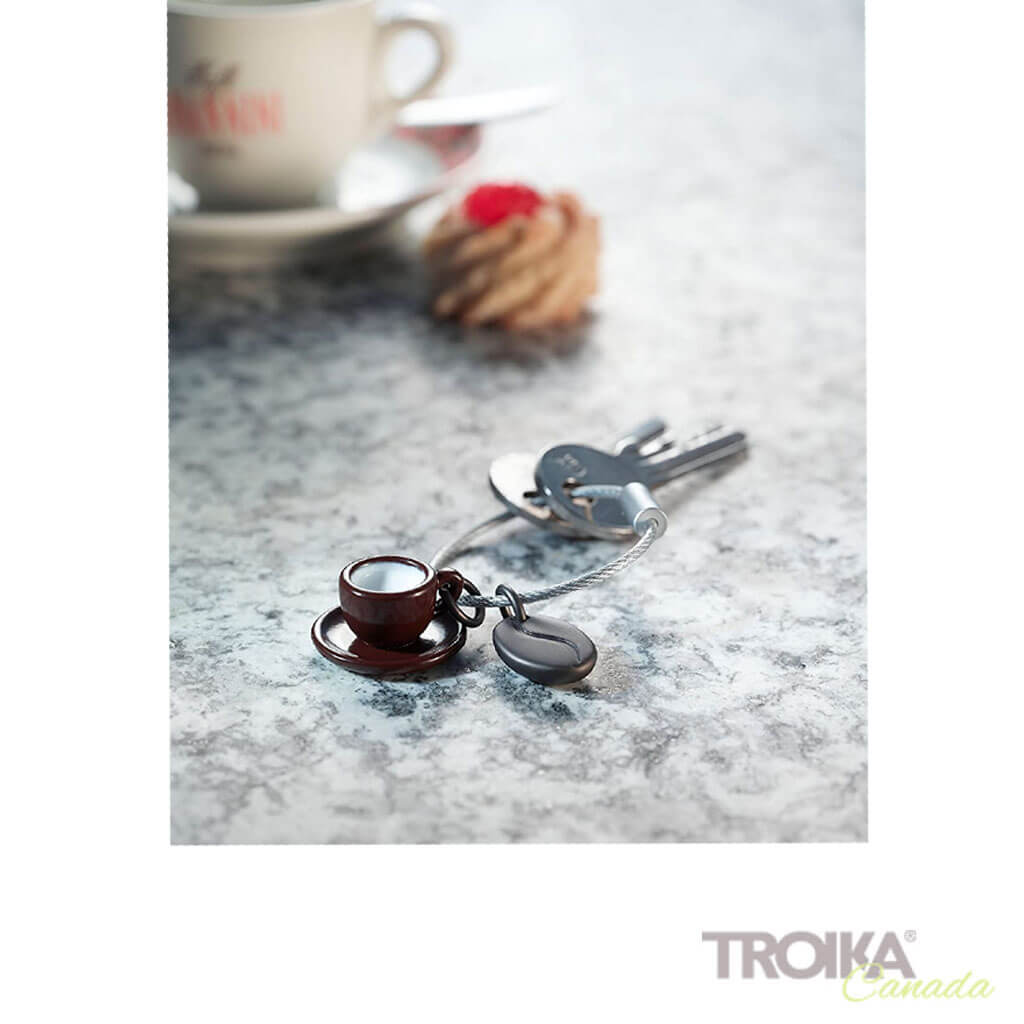 Troika keychain "Coffee 2 GO" on table with coffee mug